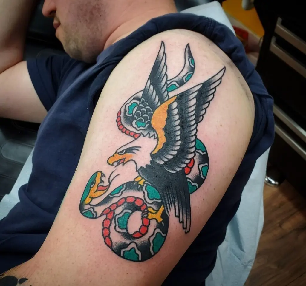 A man with a tattoo of an eagle and snake.