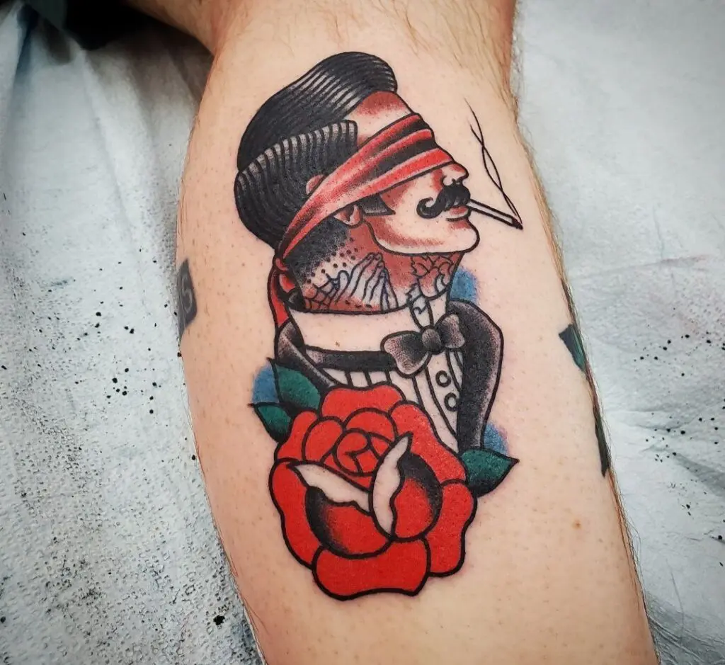 A tattoo of a man with a hat and rose.